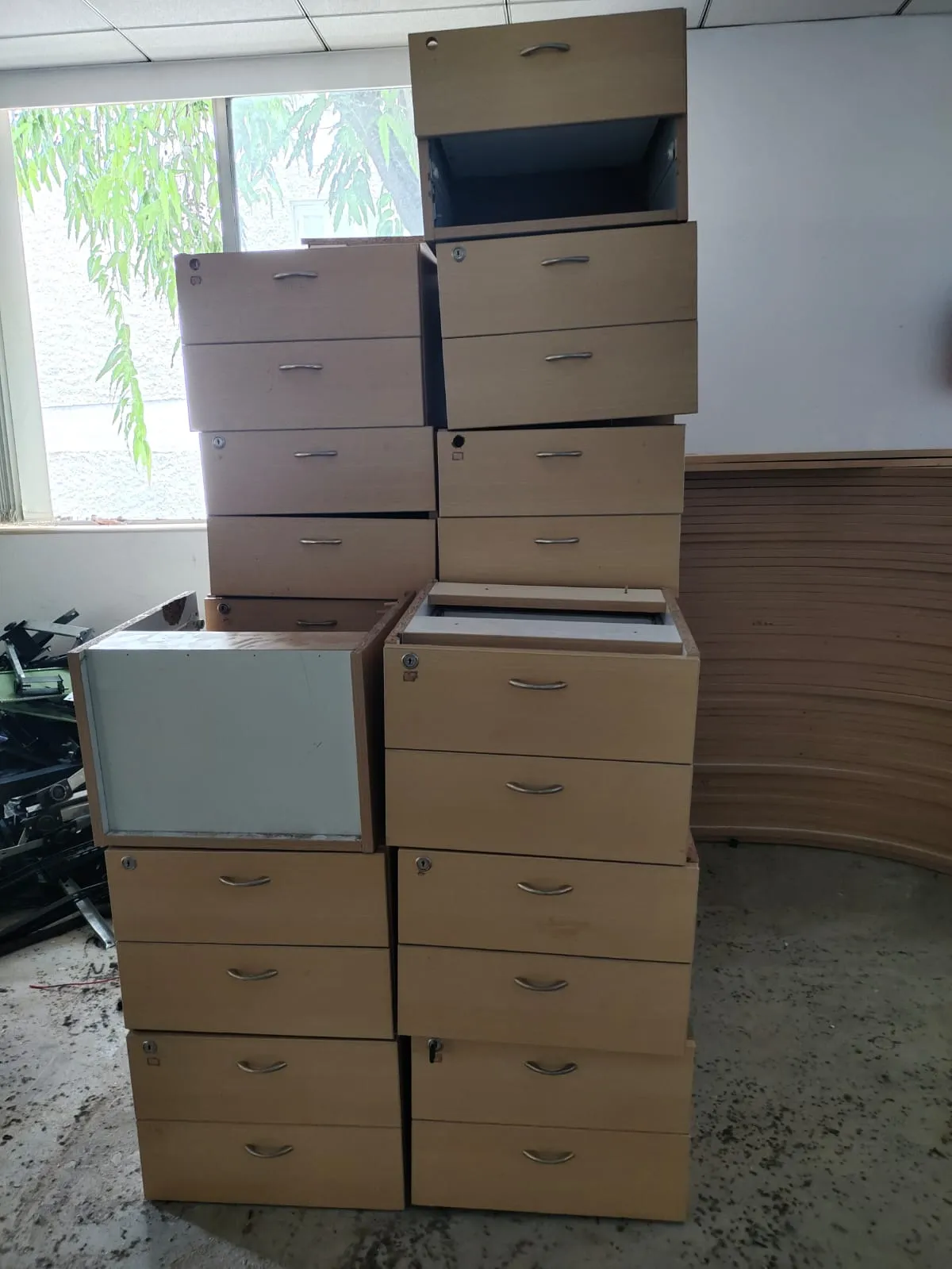 Wooden worktops and modular cubicle partitions flat-packed during a professional office furniture dismantling Bellandur project.