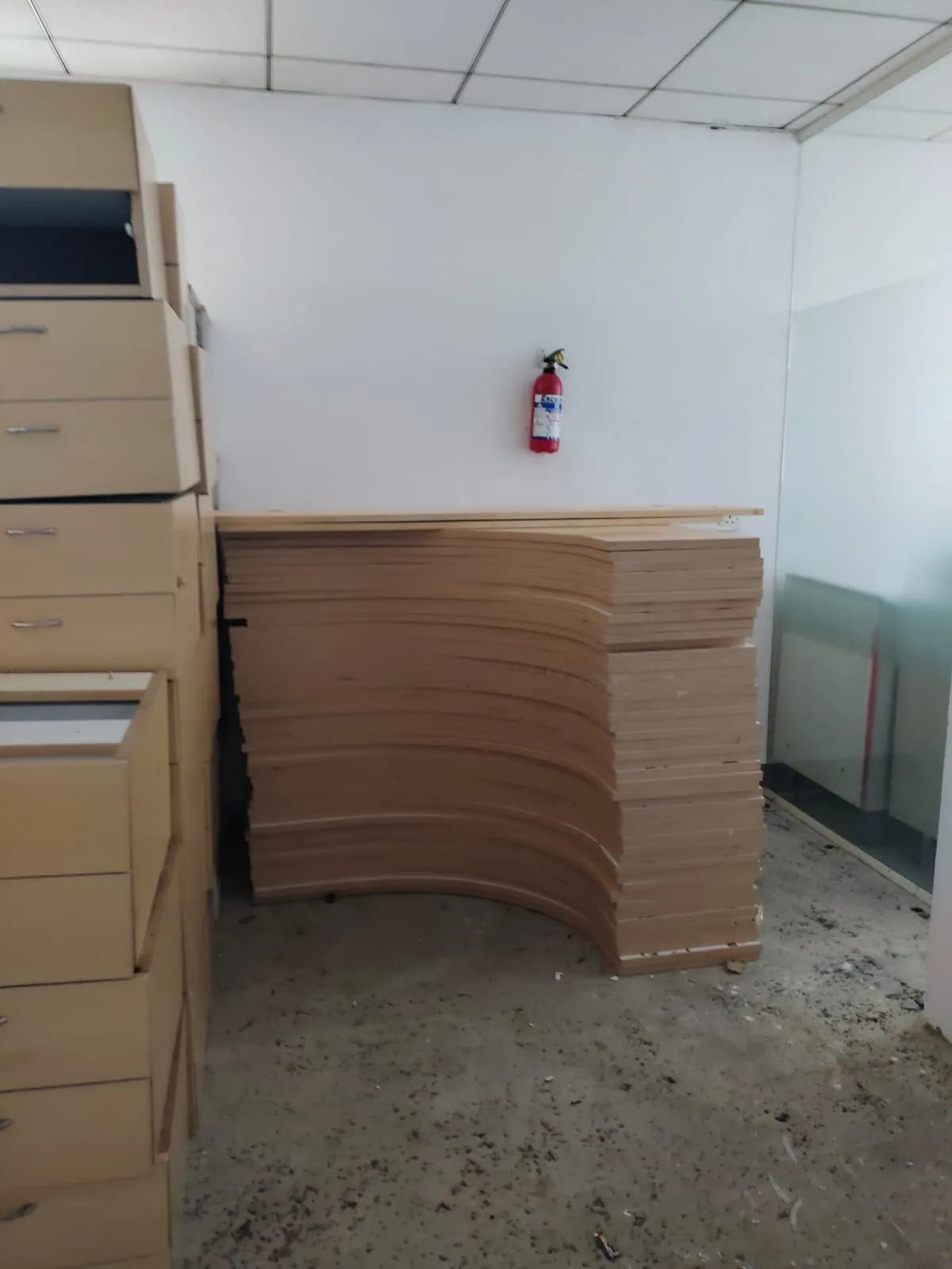 Flat-pack structural table panels stacked neatly on a construction site during a premium office shifting services Bellandur move
